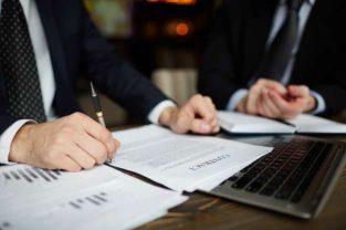 Businessman Contract Reading| Unfair Dismissals