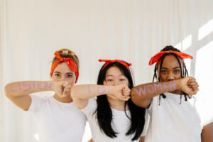 Portrait-of-multi-ethnic-group-of-women-showing-their-arms-with-the-written-words-"listen-to-women"