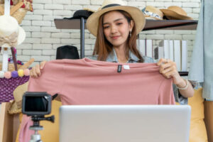 Female-employee-working-part-time-as-a-blogger-presenting-clothes-and-selling-online-live-streaming. 