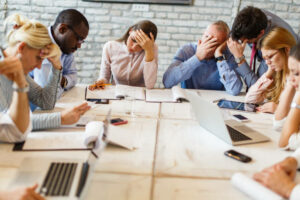 Large-group-of-business-colleagues-feeling-frustrated-on-a-meeting-in-the-office.