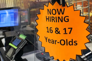 Now-hiring-sign.-Young-worker-wins-is-important-for-employee-rights.