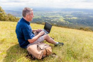 Employee-working-on-laptop-outdoors