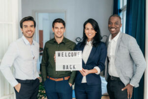 Employees-with-welcome-back-sign