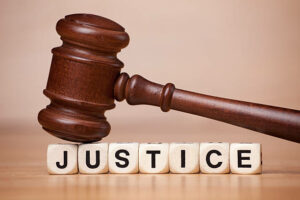 A-gavel-resting-on-letter-cubes-that-spell-JUSTICE.