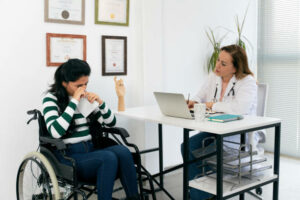 Psychological-help-for-disabled-people. -Handicapped-young-employee-crying-during-consultation-with-a-doctor-at-office.