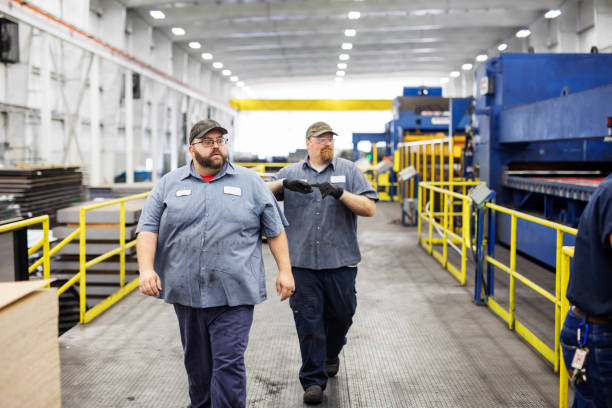 Two-large-employees-walking-through-a-factory.-When-fat-shaming-gets-you-dismissed.