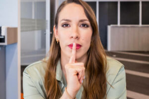 Female-employee-with-a -finger-to-her-lips